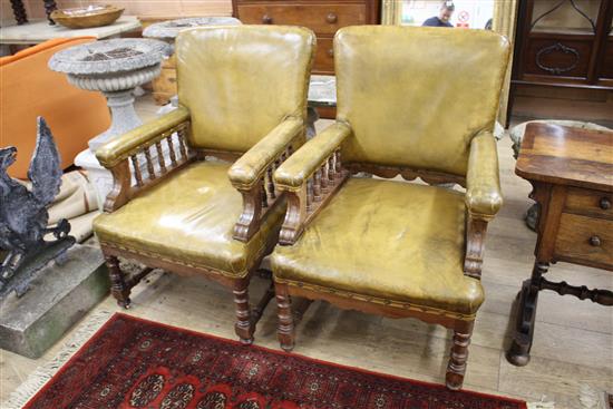 A pair of Victorian oak library chairs, upholstered in brown leather, W.68cm D.76cm H.102cm